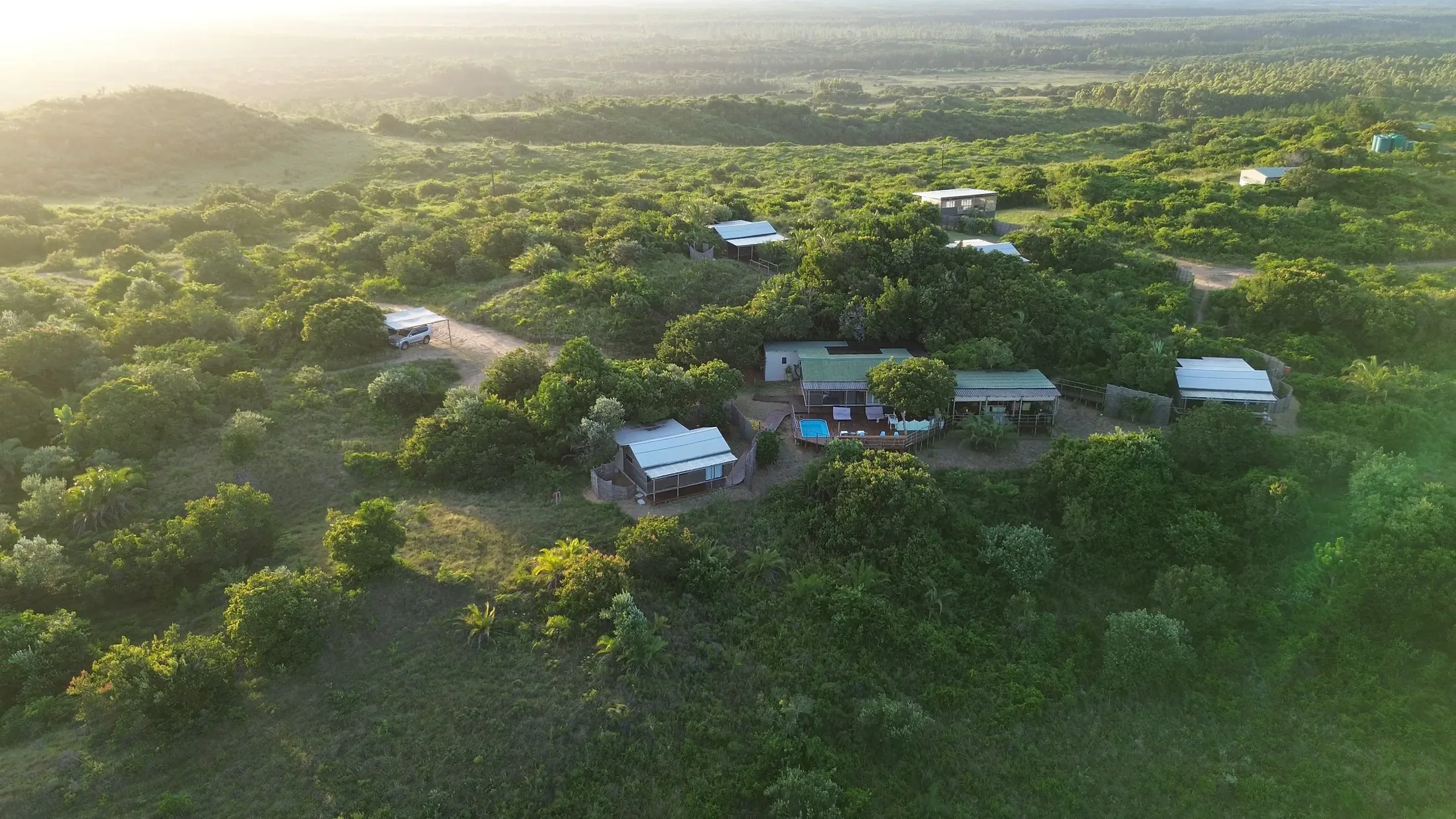 Aerial view of Big Skies Ubunye set in the coastal forest at sunset